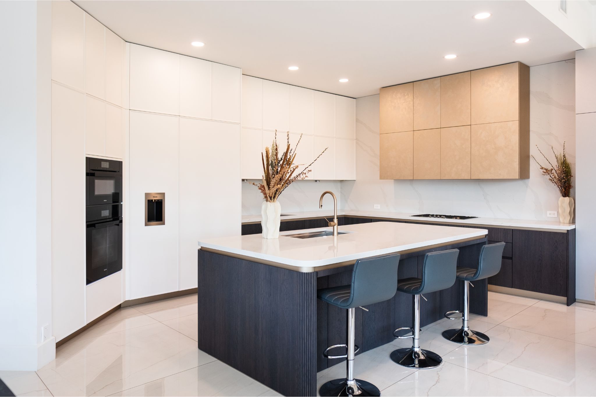 Black and white kitchen with custom golden kitchen hood