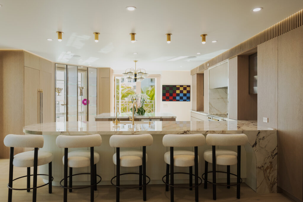 This custom Stevali kitchen features a beautiful combination of Stained oak wood veneer, a liquid metal lacquer finish, and both fluted glass and wood cabinets.