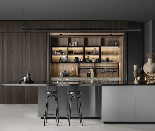 Ribbed Wood and Steel in a Spectrum’s Formenove Kitchen The Kitchen designers at Spectrum Fine Cabinetry are captivated by contrasts, beautifully pairing the allure of ribbed wood cabinet fronts with sleek steel elements in this striking kitchen. The kitchen island particularly showcases this dynamic combination of materials.