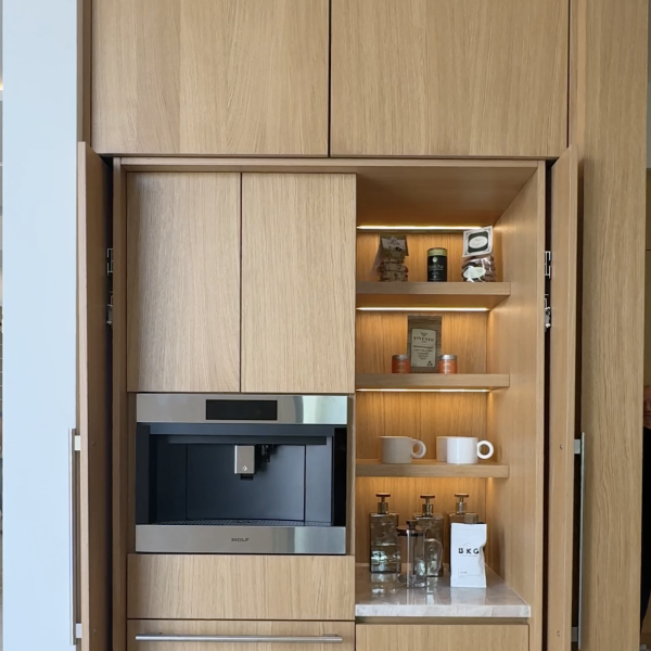 Integrated coffee station in rift cut oak, a built-in coffee maker, and illuminated shelves to display your cups and accessories