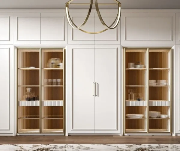 Luxurious kitchen wall featuring white paneled cabinetry, two large display cabinets with fluted glass doors and warm wood interiors, flanking a central set of white double doors.