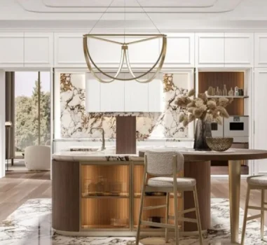 Luxurious white and gold Italian kitchen featuring a round central island with a marble countertop and glass-front cabinets, surrounded by white cabinetry with gold accents and fluted glass details. A striking gold geometric pendant light hangs above the island.